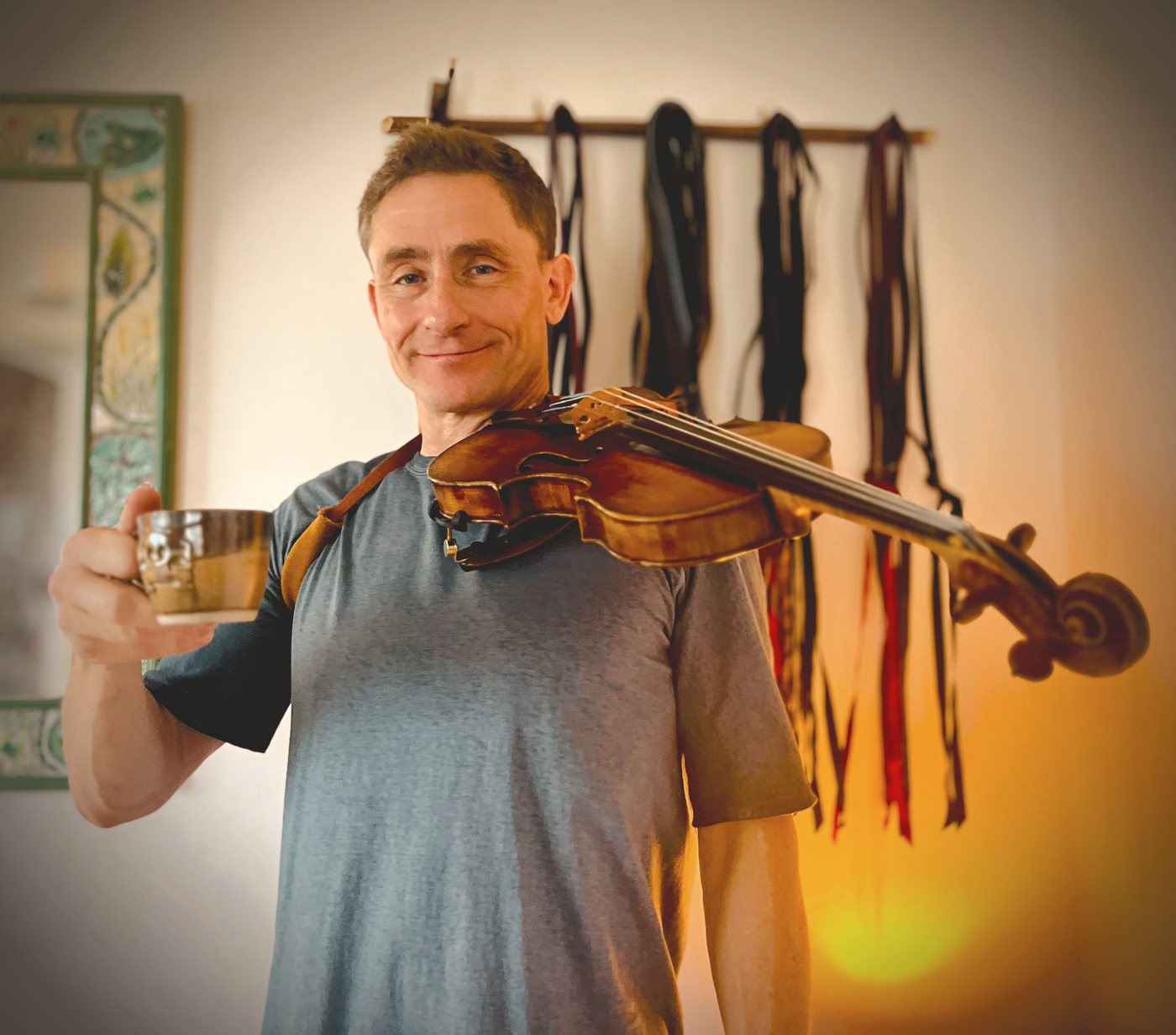 Chad Manning smiling with fiddle on shoulder